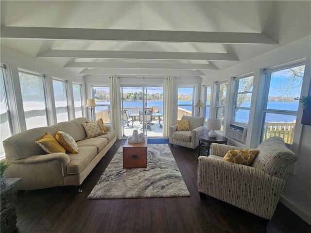 sunroom / solarium with a water view, beam ceiling, and a wealth of natural light