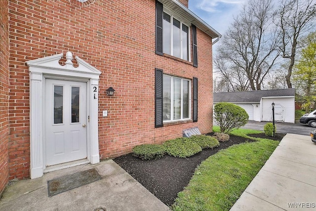 property entrance featuring brick siding