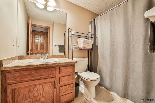 full bath with vanity, a textured ceiling, tile patterned floors, and toilet