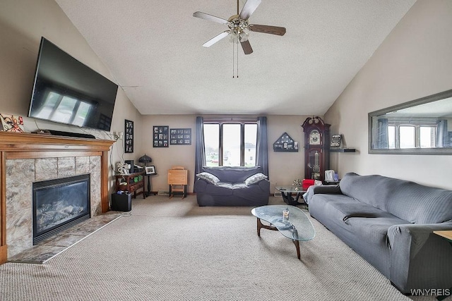 carpeted living area with a textured ceiling, vaulted ceiling, a wealth of natural light, and a fireplace