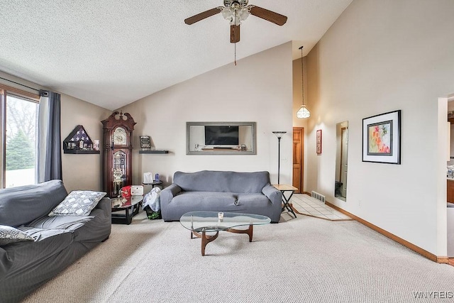 living area featuring light colored carpet, high vaulted ceiling, a ceiling fan, baseboards, and visible vents