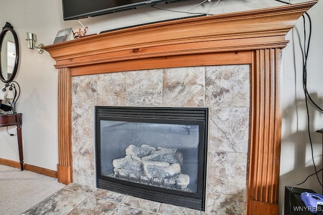 room details featuring baseboards and a fireplace