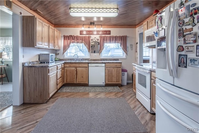 kitchen with white appliances, crown molding, a sink, and light wood-style flooring