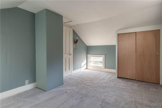 bonus room with baseboards, carpet flooring, and lofted ceiling