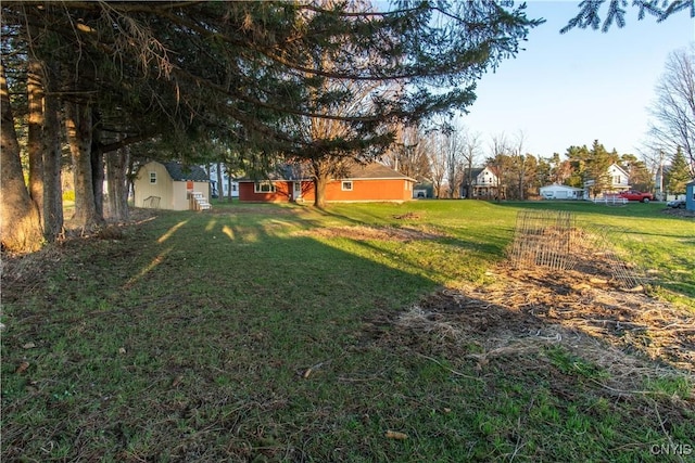 view of yard with an outdoor structure and a shed