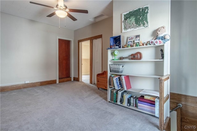 rec room with carpet floors, a ceiling fan, and baseboards