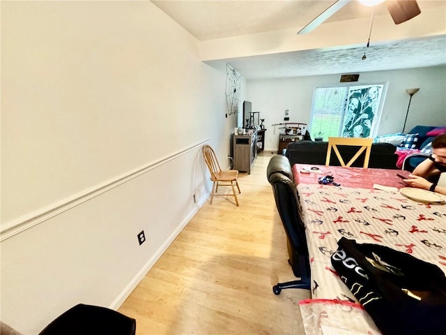bedroom featuring baseboards, light wood-style flooring, and ceiling fan