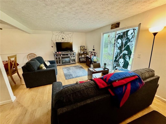 living area featuring a textured ceiling and wood finished floors
