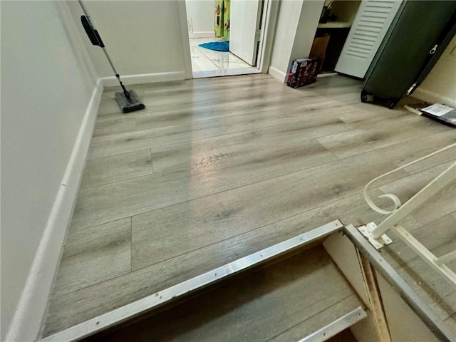 interior details with baseboards and wood finished floors