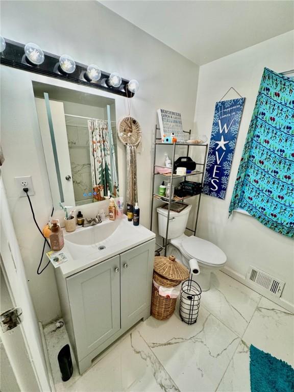 bathroom with visible vents, vanity, marble finish floor, toilet, and a shower with shower curtain