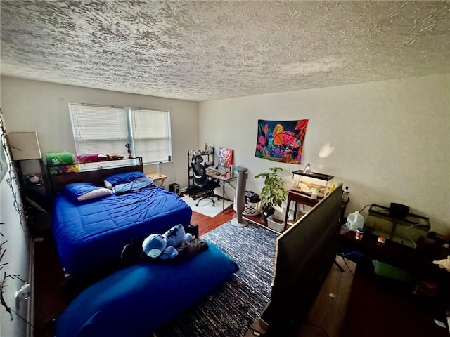 bedroom featuring a textured ceiling and wood finished floors