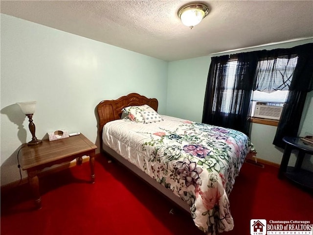 carpeted bedroom featuring baseboards, cooling unit, and a textured ceiling
