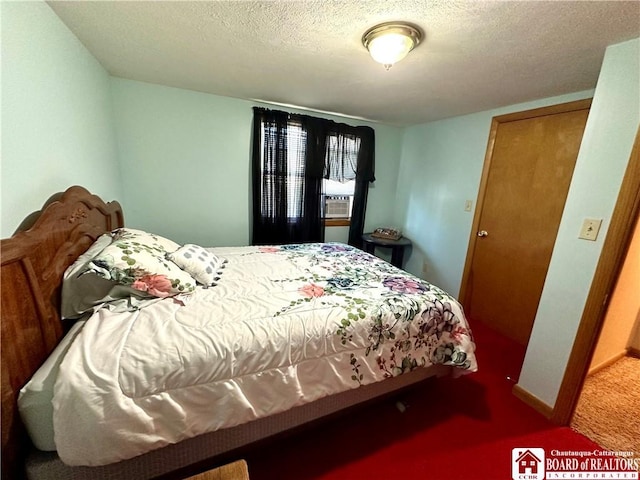 bedroom featuring carpet flooring and a textured ceiling