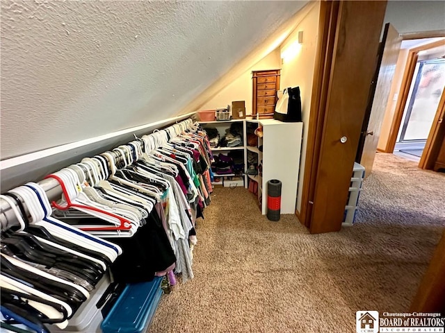 spacious closet with carpet and lofted ceiling