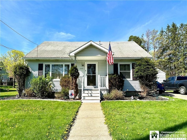 bungalow-style home with a front yard