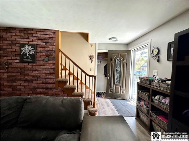 entryway with wood finished floors and stairway