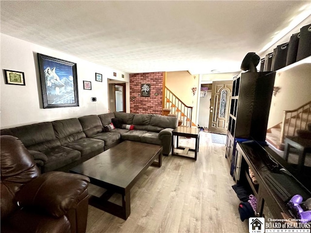 living room with light wood-style floors and stairs