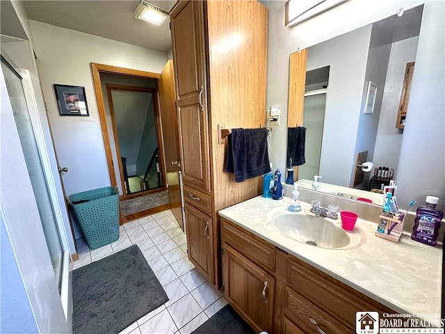 bathroom featuring tile patterned floors, a shower stall, and vanity
