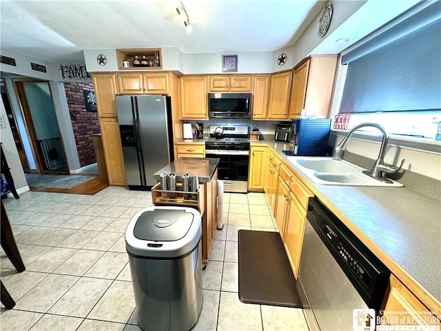 kitchen with visible vents, a center island, a sink, light tile patterned floors, and stainless steel appliances