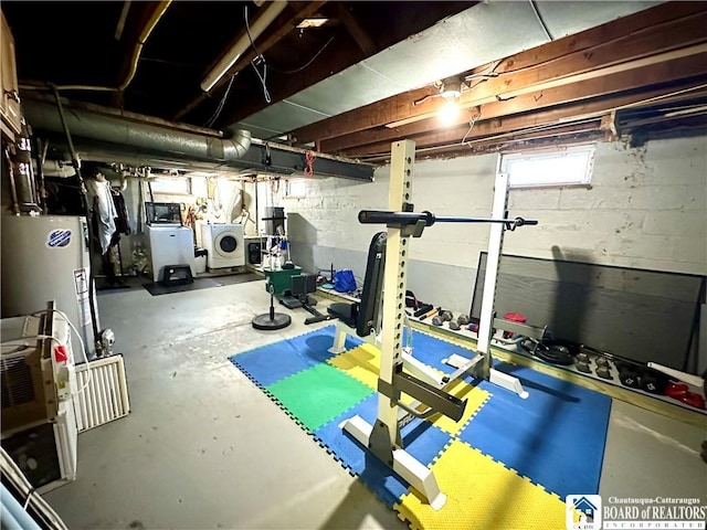 workout area with water heater and washing machine and clothes dryer