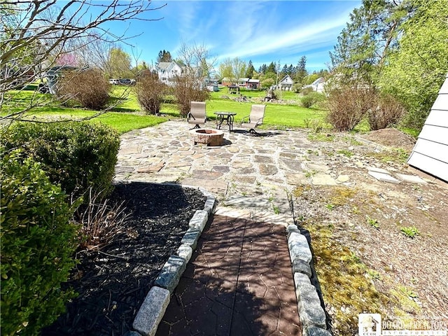 view of yard with a fire pit and a patio area