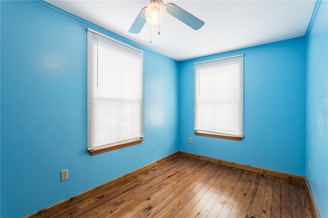 empty room featuring baseboards, ceiling fan, and hardwood / wood-style flooring