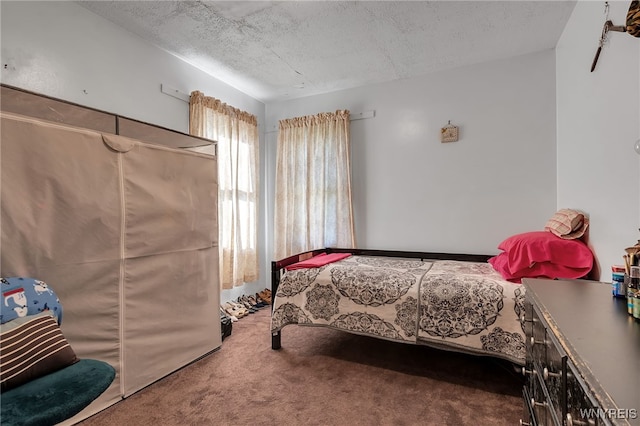 carpeted bedroom featuring a textured ceiling