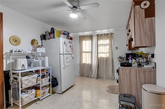 kitchen with freestanding refrigerator, a ceiling fan, and light tile patterned floors