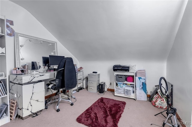 carpeted office space featuring vaulted ceiling