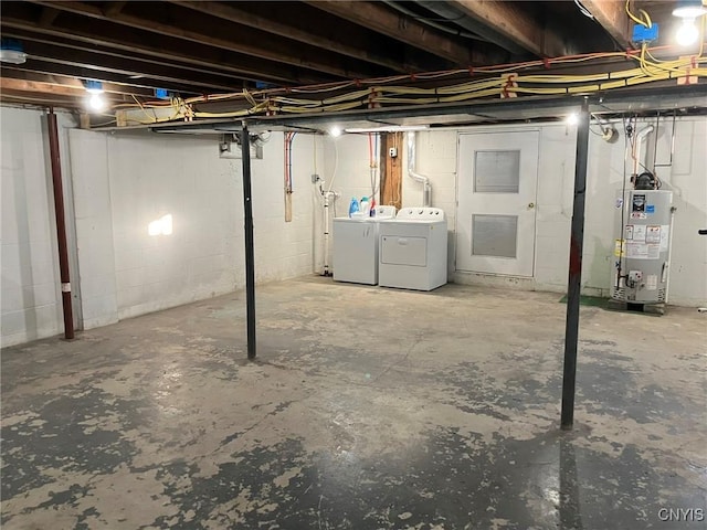 unfinished basement featuring water heater and washing machine and clothes dryer
