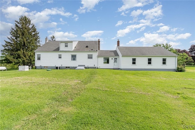 2203 State Route 90th Rd, Ledyard, NY 13026 - back of property with a yard, a chimney, and a shingled roof