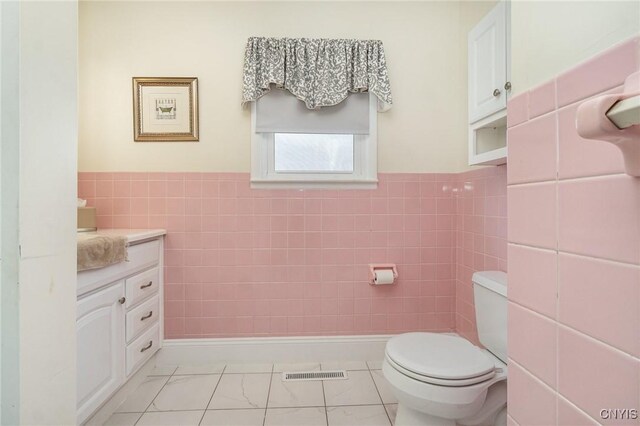 2203 State Route 90th Rd, Ledyard, NY 13026 - bathroom with tile walls, toilet, wainscoting, vanity, and marble finish floors