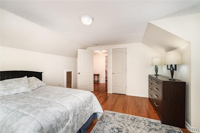 2203 State Route 90th Rd, Ledyard, NY 13026 - bedroom featuring wood finished floors, vaulted ceiling, and baseboards