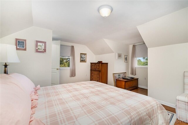 2203 State Route 90th Rd, Ledyard, NY 13026 - bedroom with wood finished floors, vaulted ceiling, and baseboards