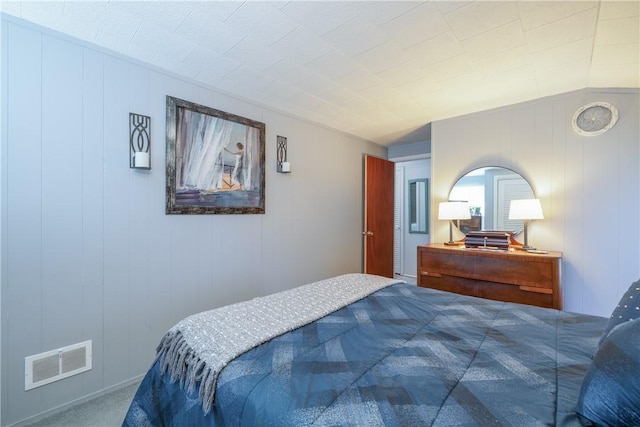 carpeted bedroom featuring visible vents