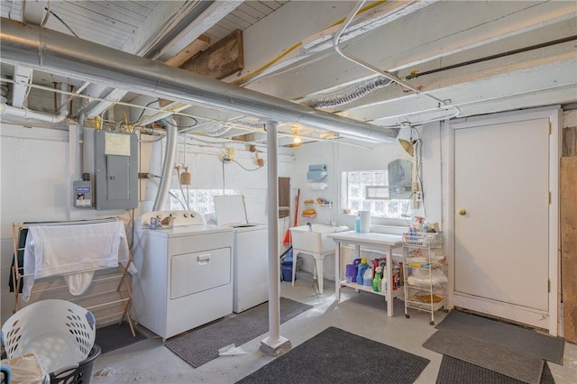 below grade area with a sink, washing machine and dryer, and electric panel
