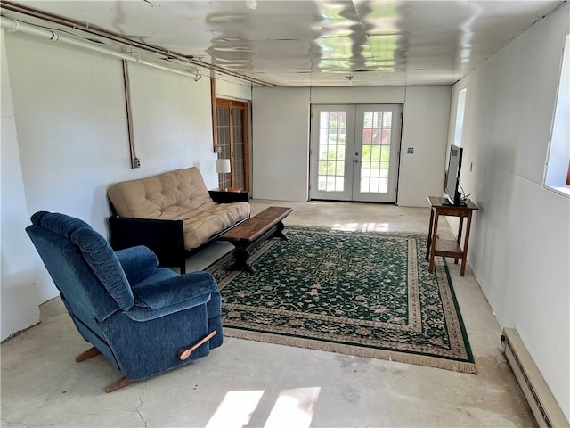 living area with baseboard heating, french doors, and concrete floors