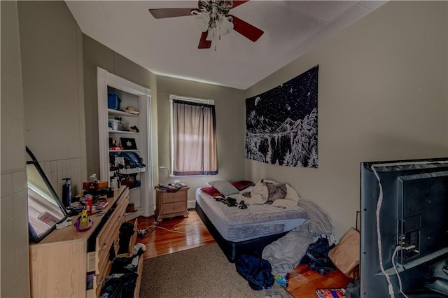 bedroom with ceiling fan and wood finished floors
