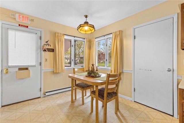 dining space featuring baseboards and a baseboard heating unit