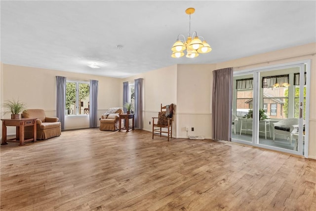 interior space featuring light wood-style flooring and a chandelier