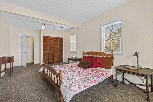 bedroom featuring a closet, carpet, baseboards, and visible vents