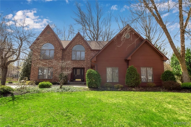 view of front of house with brick siding and a front yard