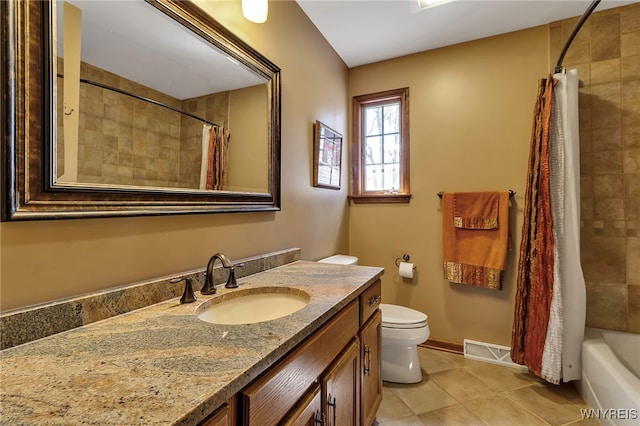 bathroom featuring tile patterned flooring, vanity, toilet, baseboards, and visible vents