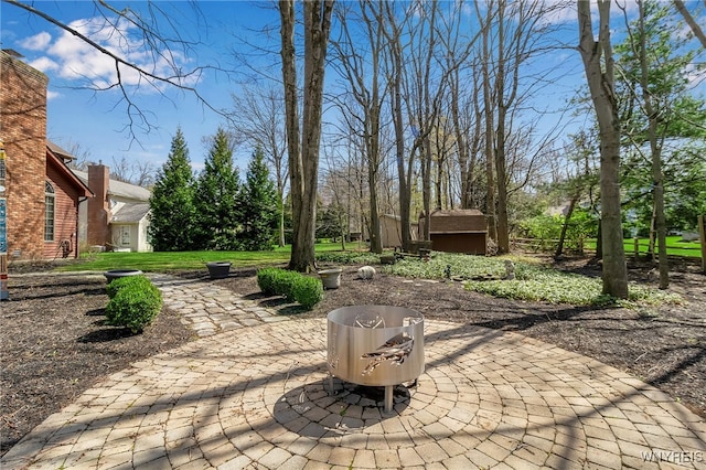 view of patio / terrace featuring an outdoor structure and a shed