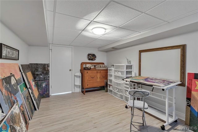home office featuring wood finished floors, baseboards, and a drop ceiling