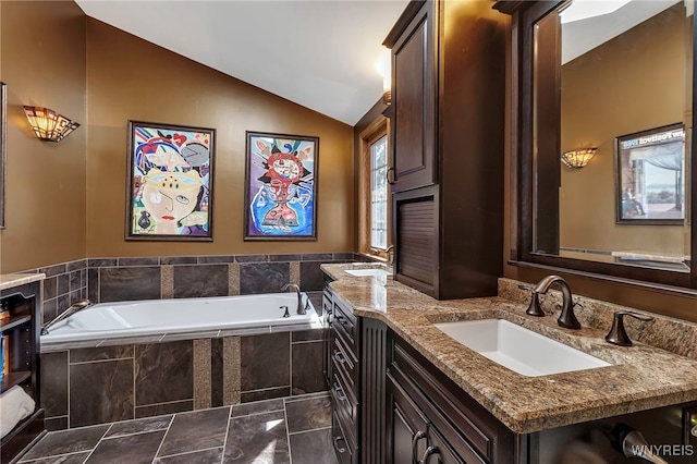 full bath with vanity, vaulted ceiling, and a garden tub