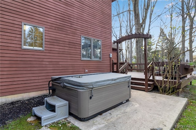 exterior space with a patio, a hot tub, and a deck