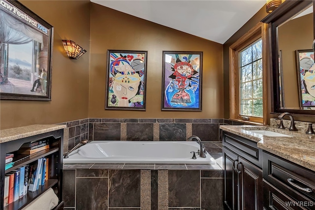 full bathroom with vaulted ceiling, a bath, and vanity