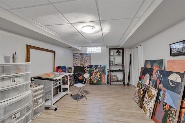 interior space featuring a drop ceiling and wood finished floors