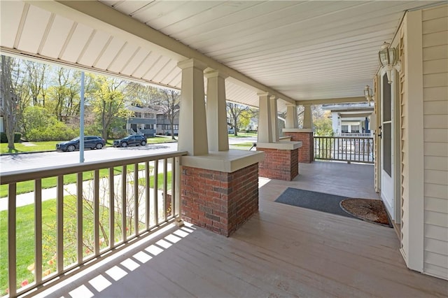 wooden terrace with a porch and a residential view